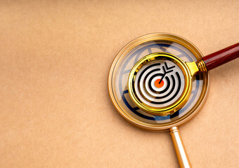 Information search, digital data online global searching, research, concepts. Target icon on small magnifier lens stacked on big magnifying glass with world symbol on brown background with copy space.