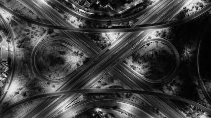 Paved asphalt roads and streets, a black and white overhead photo of car traffic on the general...