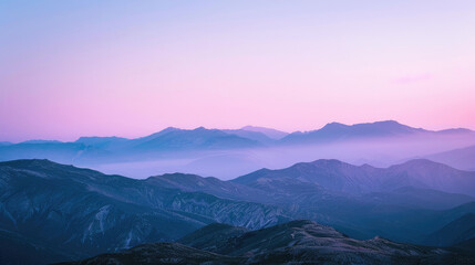 Fototapeta premium Serene mountain silhouettes cast in soothing purple hues of dusk