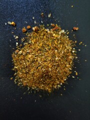 Variety of colorful spices such as turmeric, cumin, and paprika arranged in a messy pile on top of...
