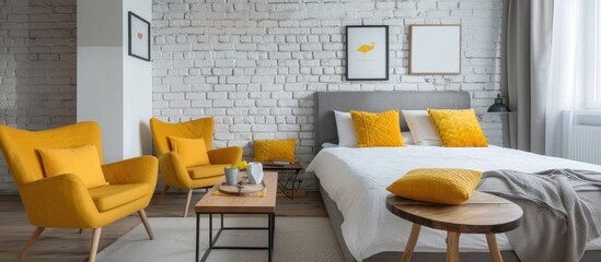 A roomy bedroom featuring a white brick wall, a wooden coffee table, and yellow chairs. Adjacent to...