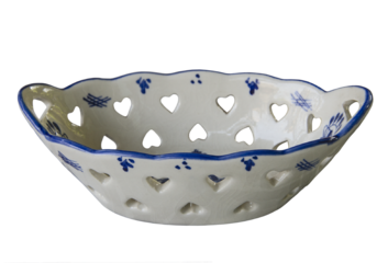 Ceramic bowl with heart shaped holes and pattern around sides on white background