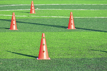 artificial green grass soccer field with orange training cones - 788900823