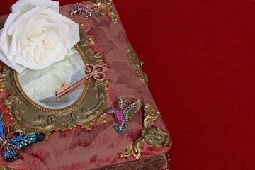 Naklejka premium Antique Fairy Tale Book With Jewels and White Rose