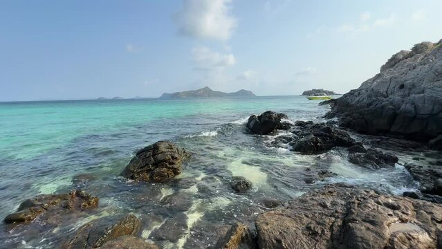 Beautiful tropical beach with black rocks	