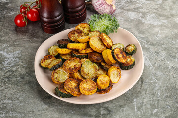 Roasted young zucchini in the plate
