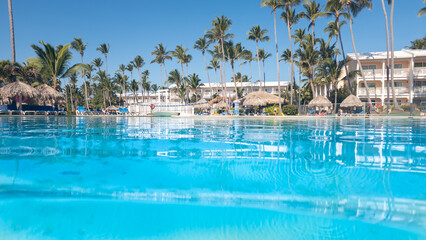 Pretty swimming pool in a large hotel in Punta Cana in the Dominican Republic - obrazy, fototapety, plakaty