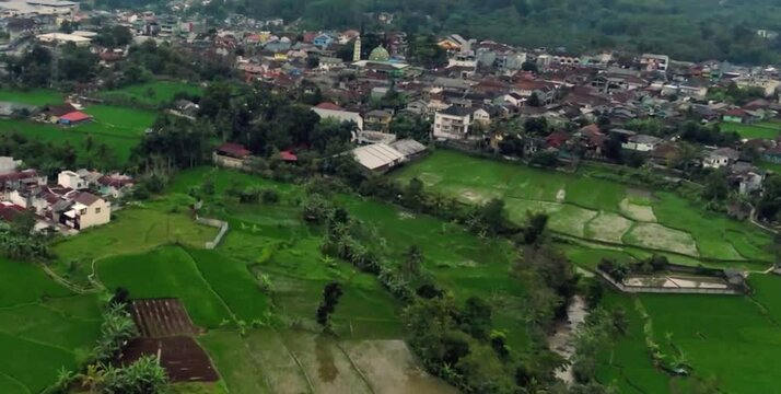 aerial video of the expanse of rice fields and rural settlements in mountainous areas that are currently foggy