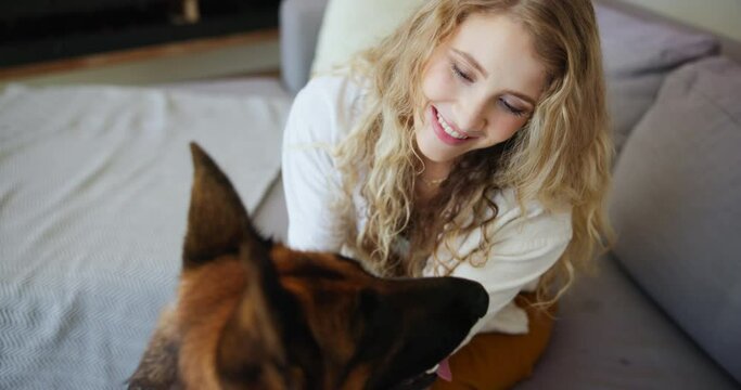 Woman, dog and pet with smile, happiness and bonding for therapy with service animal. Girl, love and friendship with german shepherd, quality time and couch in apartment or home living room with care