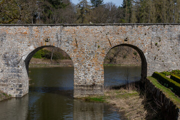 A double-arched stone bridge. A medieval stone bridge.
