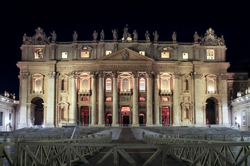 Night view of Saint Peter's Basilica in Vatican City, the papal enclave in Rome, highlighting its...