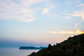 Landscape view across water to small islands at sunset in Croatia.