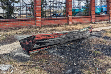 An abandoned old boat on the riverbank on a spring day