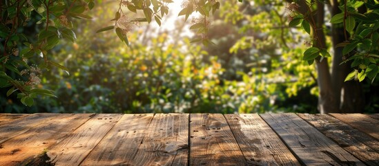 Naklejka na ściany i meble Wooden planks on a backdrop of spring foliage