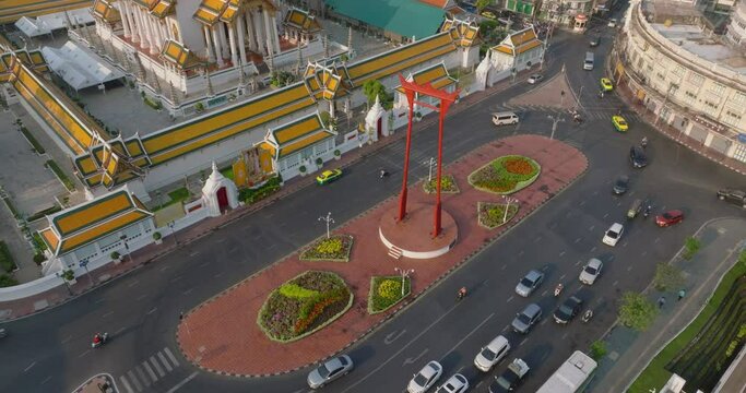 An aerial view of Red Giant Swing and Suthat Thepwararam Temple at sunset scene, The most famous tourist attraction in Bangkok, Thailand.