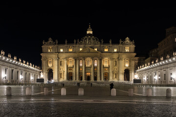 Night view of Saint Peter's Square in Vatican City, the papal enclave in Rome, with the Vatican obelisk, an ancient Egyptian obelisk, at the centre and St. Peter's Basilica in the background. 