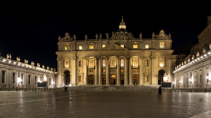 Night view of Saint Peter's Square in Vatican City, the papal enclave in Rome, with the Vatican obelisk, an ancient Egyptian obelisk, at the centre and St. Peter's Basilica in the background. 
