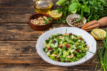 Fresh salad with herbs, apples and cranberries	
