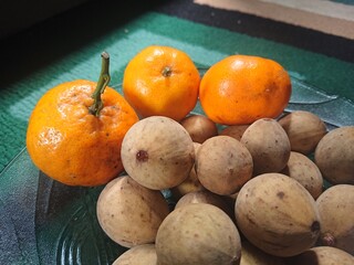 Fresh duku and orange fruit.
