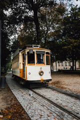 View of a park with the famous retro tourist streetcar in the old town of Porto, Portugal. Traditional Tram - 788958029