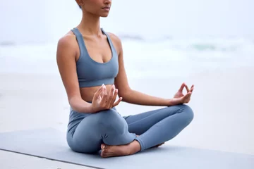  Yoga, lotus meditation and hands at ocean for mindfulness, peace or calm to relax at sea in nature. Zen, beach and woman in padmasana pose for exercise, fitness and wellness for body health outdoor © peopleimages.com