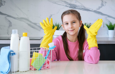 An emotional child spreads his palms, screams very loudly, wears rubber gloves, uses cleaning...