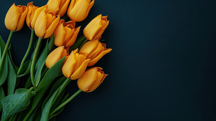 top view bouquet of yellow tulips on black background with copy space for text. greeting card or banner template