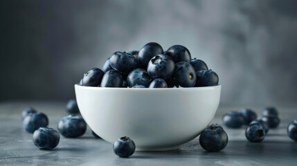 fresh blueberries in a bowl on a white table against a gray background