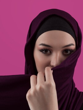 Modern Muslim woman wearing stylish hijab casual wear isolated on pink background. Diverse people model hijab fashion concept.