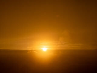 First rays of light appear of the sun new day dramatic sunrise mountains foggy morning