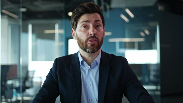 Portrait of handsome middle age man talking to camera and moving hands with friendly smile. Successful company representative inviting young graduates for internship and gaining working experience.