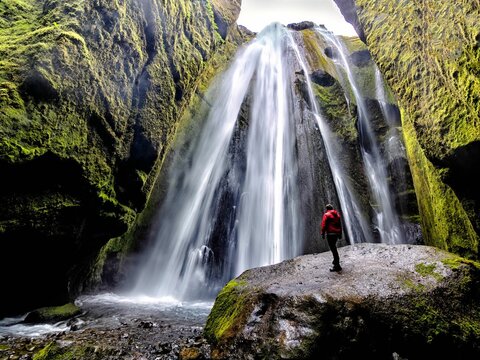 Man in red jacket posing by Gljufrabui Waterfall