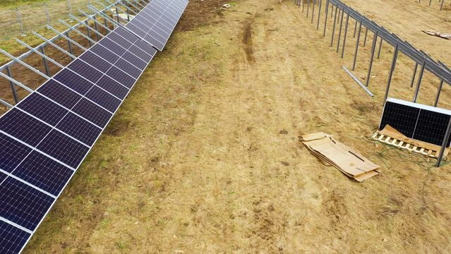 Flying between rows of solar panel farm under construction process