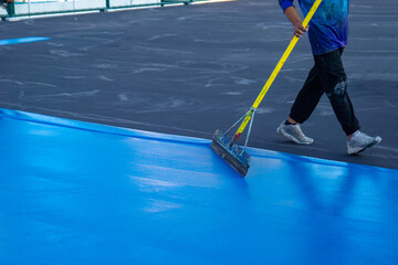 Tennis court  and sport floor painting by squeegee,Workers Spreading floor paiting with Squeegee 
