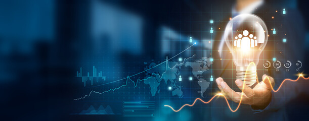 Businessman holding creative light bulb with growth graph and customer relationship management...