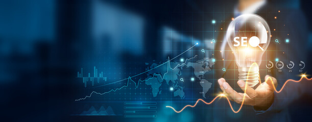 Businessman holding creative light bulb with growth graph and SEO icons. SEO innovation technology...