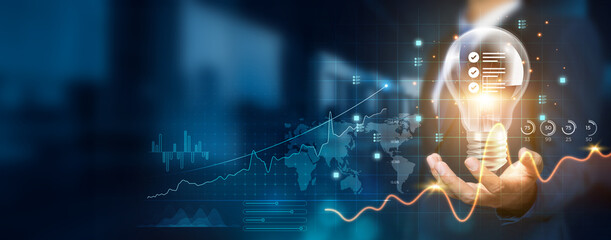 Businessman holding creative light bulb with growth graph and standard icons. Standard innovation...