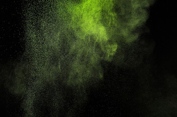 Light green powder explosion on black background. Citron color cloud. Lime dust explode. Freeze...