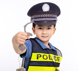 child dressed as a police officer standing and showing handcuffs
