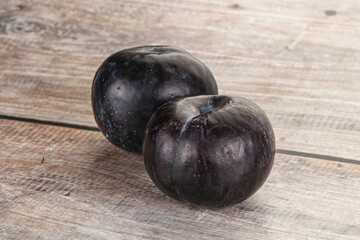 Two ripe sweet black plums