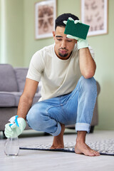 Cleaning, floor and exhausted man in home with spray for chores, housework or responsibility....