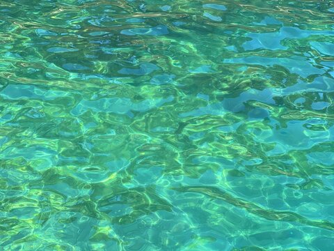 Amazing clear sea water emerald blue surface 