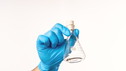 Hand in blue glove holding empty tube for laboratory research. Concept of Experimental Research in...