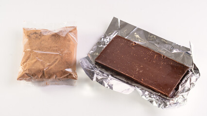 Milk chocolate made from high-quality cocoa. Cocoa and chocolos on white background, concept of price increase for raw materials of chocolate production