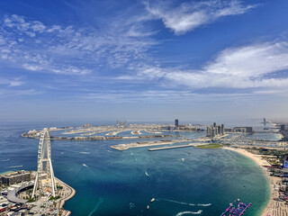 aerial city view of Dubai with the artificial island Palm Jumeirah, JBR Beach, Marina Beach and many other famous buildings along the coastline of Dubai