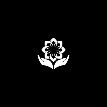 Lotus in hands logo icon isolated on dark background