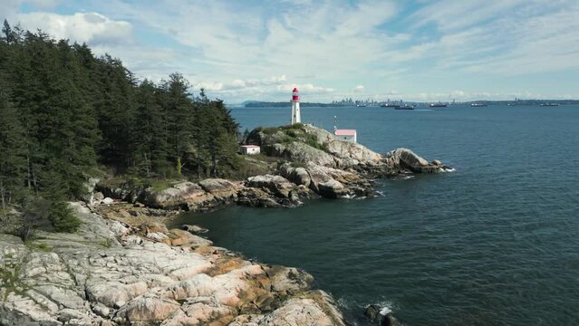 aerial shot toward point atkinson lighthouse in Lighthouse park  in West Vancouver near Vancouver city in british columbia in Canada