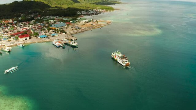 Freight ships and ferries in the bay, top view. Dapa Ferry Terminal. Siargao, Philippines.