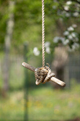 Swing made of rope and stick in the garden