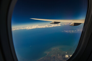 Beautiful view of the airplane wing and the sea.